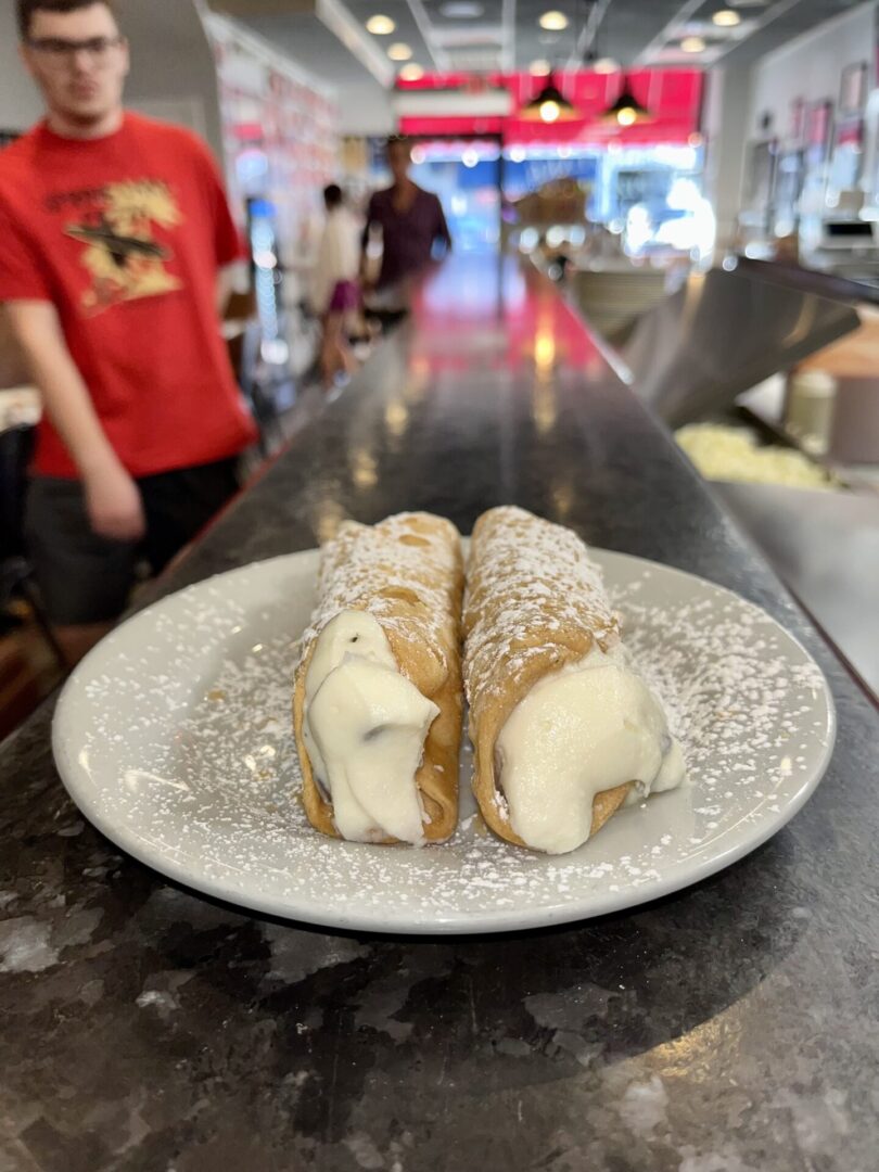 Two pastries are on a plate in front of the counter.