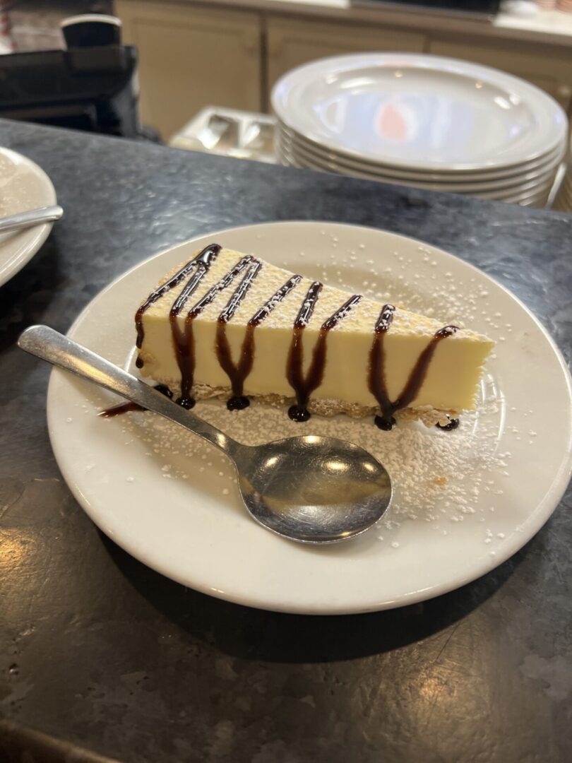 A piece of cake on top of a white plate.